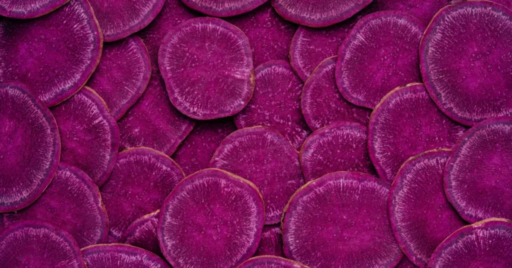 Close-up of purple potato slices with a deep, vibrant hue.