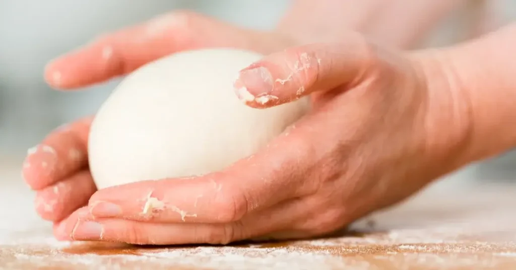 Shaping sourdough dough into a loaf