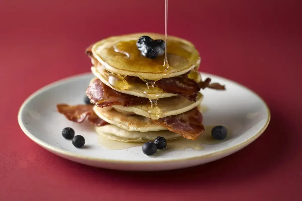 Pancakes made from sourdough discard, topped with butter and maple syrup.